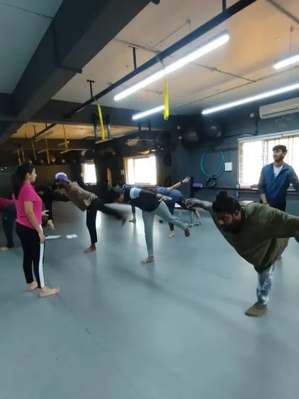 A group of students works on balance and stability, an essential skill for both athletic performance and general fitness.
