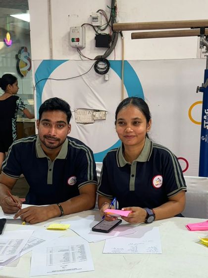 Our coaches meticulously scoring and judging at a gymnastics meet, bringing their professional expertise to every event we host or attend.