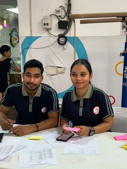 Our coaches meticulously scoring and judging at a gymnastics meet, bringing their professional expertise to every event we host or attend.