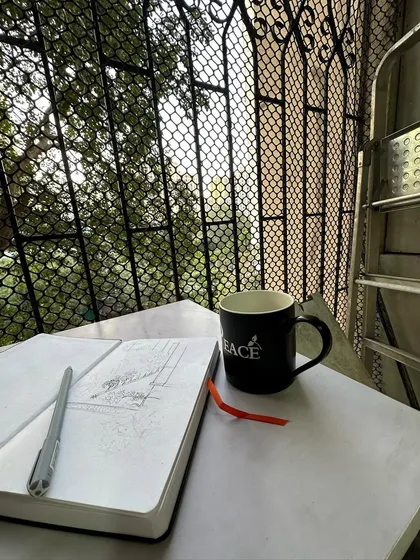 My peaceful morning setup. A cup of coffee, my sketchbook, and a nice view from the balcony.