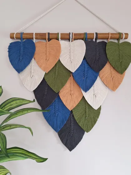 We love bringing the textures and colors of nature into your home. This macrame leaf wall hanging is handcrafted with natural cotton and can be customized with your favorite color palette to create the perfect earthy, cozy vibe for your living room or bedroom.
