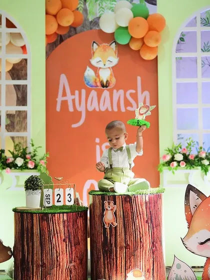 Another precious moment from the woodland-themed first birthday party. The detailed setup with the custom backdrop, log pedestals, and cute animal figures created a perfect setting for capturing these memories.