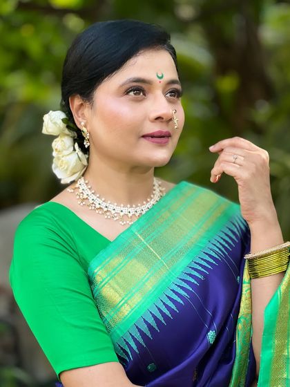 A close-up of Bhargavi's makeup, featuring a classic Chandrakor bindi and a soft, natural palette that enhances her beauty.