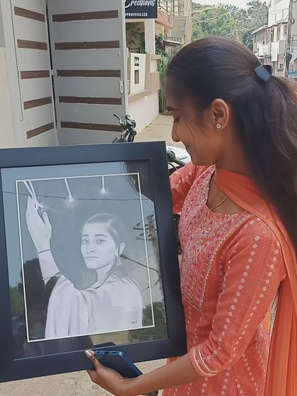 A happy client holding her newly framed portrait. Seeing my art bring smiles is the ultimate goal.