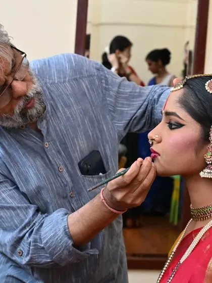 The transformation into a performer begins backstage. Here, the intricate process of applying stage makeup for my student Anvita Jain is underway, preparing her for her arangetram.