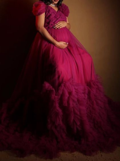 This close-up shot focuses on the beautiful bump and the texture of the magenta gown. My maternity dresses are designed to flatter your changing shape and make you feel amazing.