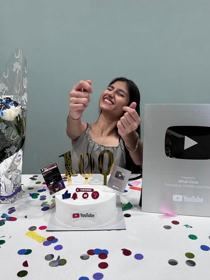 Celebrating a huge milestone: receiving my Silver Play Button from YouTube for reaching 100,000 subscribers! I even made a special YouTube-themed cake to celebrate.