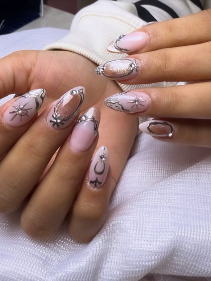 An intricate and celestial-inspired design. This set features silver chrome detailing that creates a framed effect, accented with tiny starbursts and sparkling rhinestones.