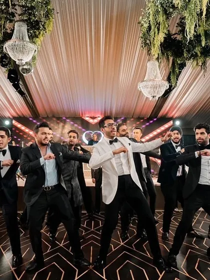 The groom's squad, dressed in sharp tuxedos, delivers a perfectly synchronized performance for a cocktail night. The clean moves and classic look were a huge hit.