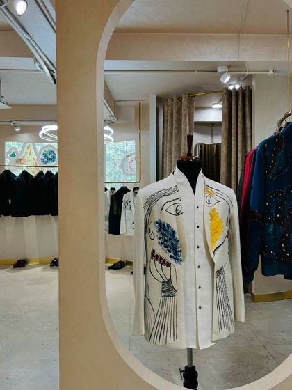 A glimpse into a designer's studio, showcasing a hand-painted shirt. Sourcing unique pieces like this is a key part of my process for creating one-of-a-kind editorial looks.