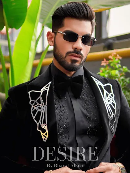 A close-up portrait in the black velvet blazer, showing the detailed embroidery and the confident gaze it inspires.