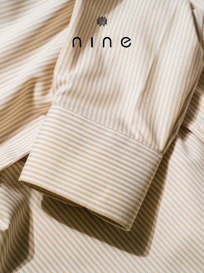 Another view of the striped shirt's cuff, showing the clean finish and classic design.