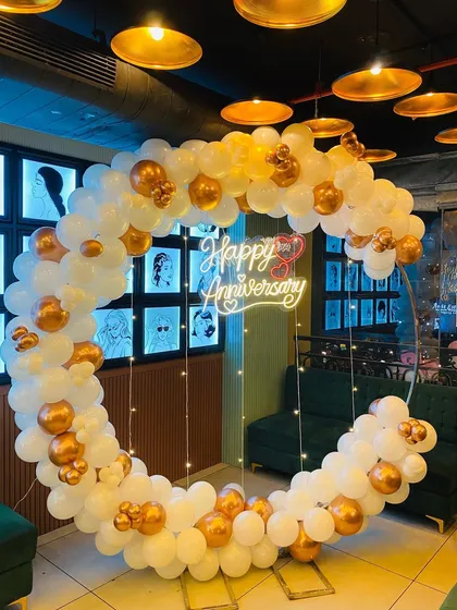 A different angle of the anniversary balloon hoop, showing how it creates a perfect frame for photos in a restaurant or event space.