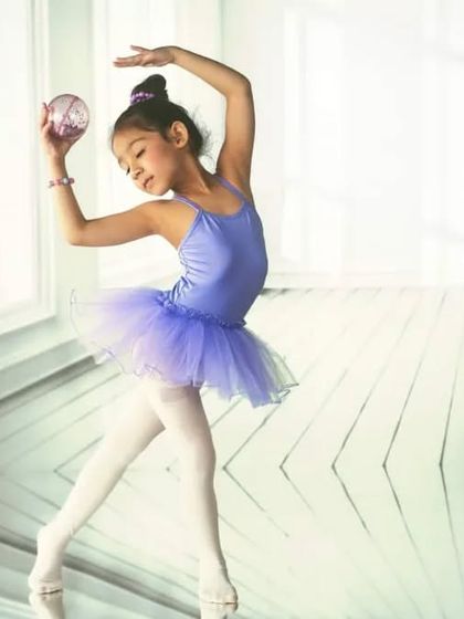 A bright, clean dance studio with large windows, created with projection. This provides the perfect minimalist and airy setting for this young ballerina's portrait.
