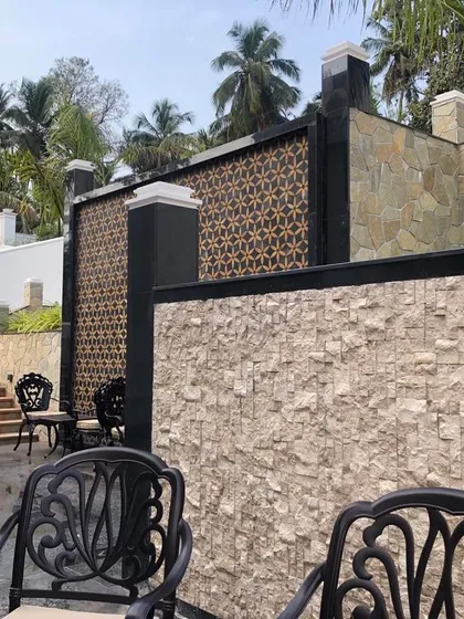 An exterior detail shot showing the interplay of different textures and materials. We used rough-hewn stone, smooth plaster, and a decorative screen to create visual interest and a rich tactile quality.