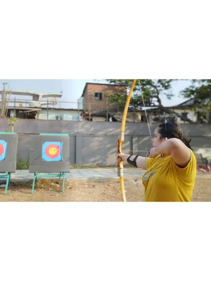 A student practices her shot at our outdoor range. Learning in a natural environment is a great experience.