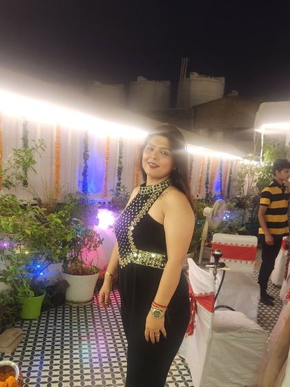 A candid shot of the client enjoying her party in the custom jumpsuit.