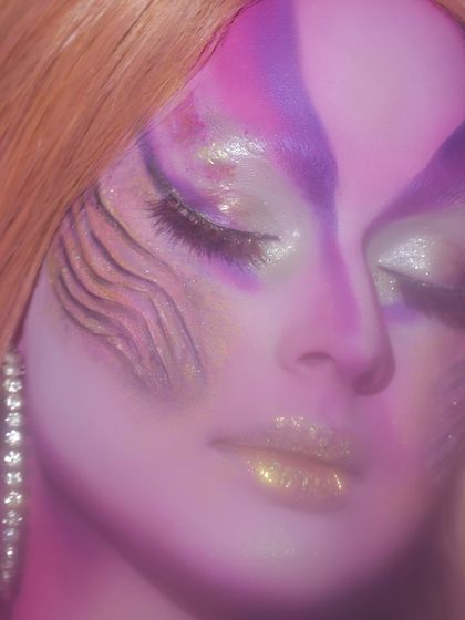 A close-up of the artistic details in a face painting look. The blending of colors and the textured cheek design showcase advanced techniques.