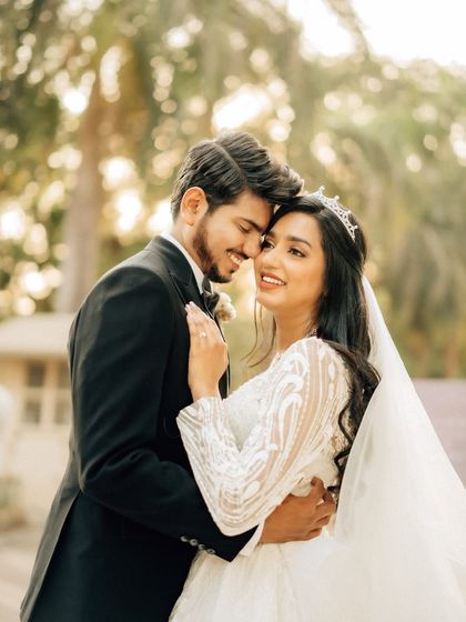A classic, romantic embrace captured in a natural outdoor setting. The soft light and genuine smiles make this a timeless couple portrait.