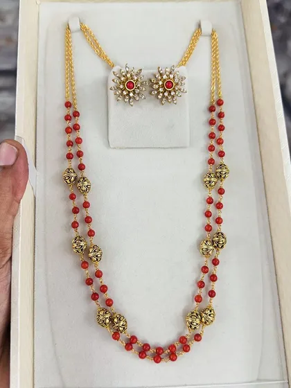 A variation of the red beaded set, this one comes with star-shaped stud earrings. The combination of red beads and antique gold-finish beads gives it a traditional yet stylish look.