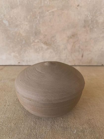 A perfectly formed lidded jar, showcasing the skill of throwing a well fitting lid. The throwing rings are still visible, adding a beautiful texture to the piece.
