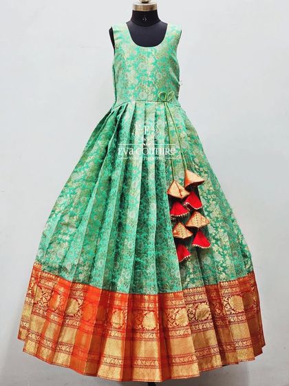 A sleeveless version of the red and green Banarasi outfit, designed as a long frock for comfort and ease of wear.