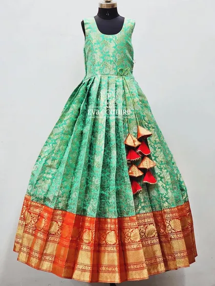 A sleeveless version of the red and green Banarasi outfit, designed as a long frock for comfort and ease of wear.