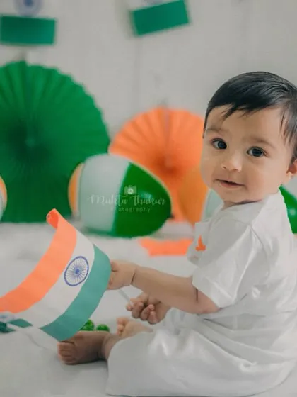 A sweet, candid moment as he plays with the Indian flag.