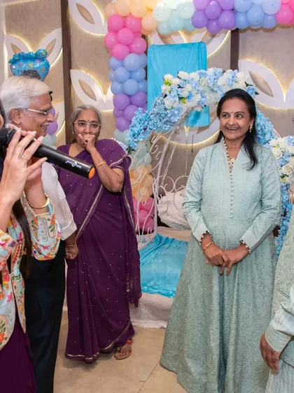 Sharing a laugh with the family elders at a naming ceremony. These candid interactions are what make an event feel personal and filled with genuine warmth.