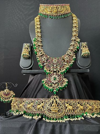 This video showcases a full bridal set with green beadwork. The set includes a choker, a short necklace, a long haaram, and an elephant-motif vaddanam, perfect for a coordinated bridal look.