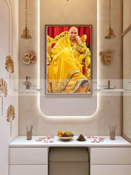 A serene and modern pooja space. The design is minimalist, with a simple white console, soft backlighting, and symbolic brass motifs. It's a peaceful corner for prayer and meditation.