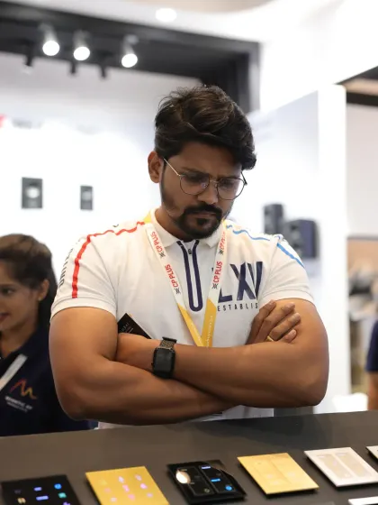 An attendee carefully examines a range of smart switch panels. The opportunity for direct product evaluation is a major draw for professionals visiting the expo.