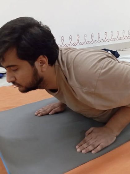 A participant in Bhujangasana, or cobra pose, a posture that strengthens the spine and opens the chest.