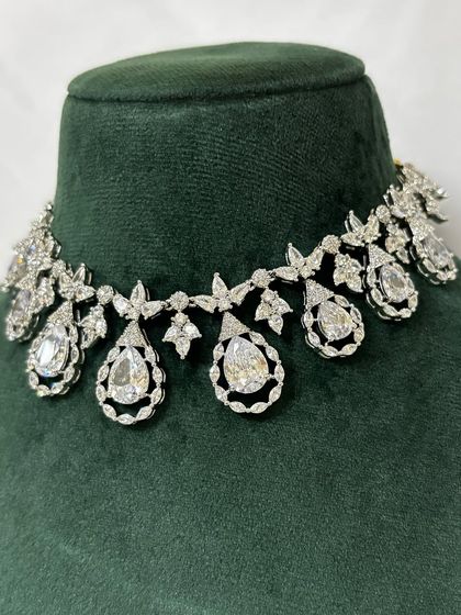 A close-up of an American diamond choker with floral and teardrop motifs. This rental piece is both delicate and sparkly.