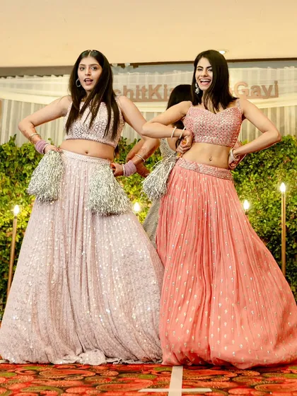 Bridesmaids with pom poms! We are all for adding fun props to make a performance pop and show that cheerleader energy for the bride.