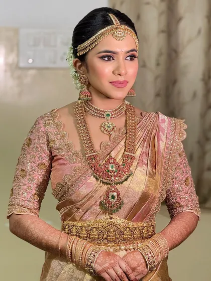 A side profile of the bride, highlighting the elegant contouring and the way the makeup enhances her features.