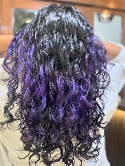 Just a pop of purple to brighten up your hair. This is a fantastic way to add a creative touch with peekaboo highlights that look stunning on dark hair.