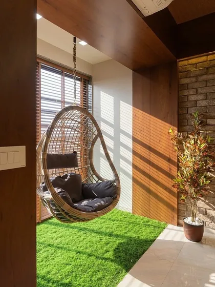 Bring the feeling of grass indoors. I installed this patch of artificial turf in a sunny corner to create a dedicated relaxation spot with a hanging swing chair, making it feel like a private garden.