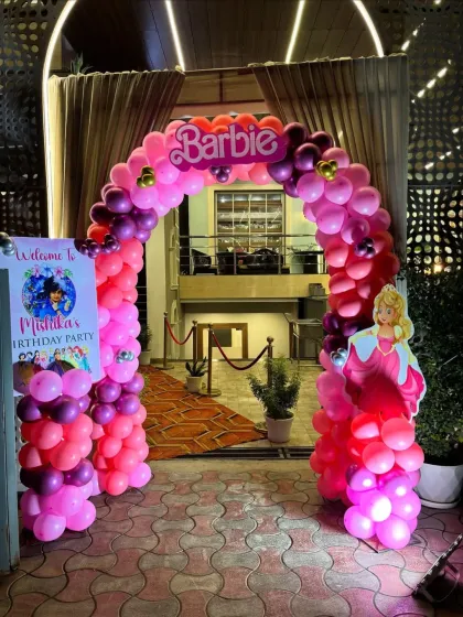 The entrance to a party sets the tone. For this Barbie-themed event, we created a vibrant pink and purple balloon arch with the iconic Barbie logo to welcome guests in style.