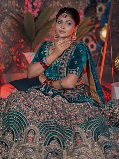 A close-up of the beautiful details on the blouse and the rich color of the makeup.