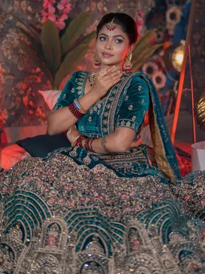 The model posing, showing the full grandeur of the bridal lehenga.