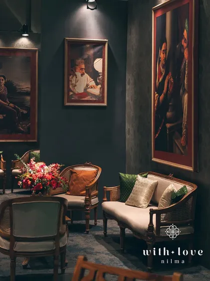 An intimate lounge corner, perfect for quiet conversations amidst the celebration. The decor is rich and layered, creating a warm and inviting atmosphere.