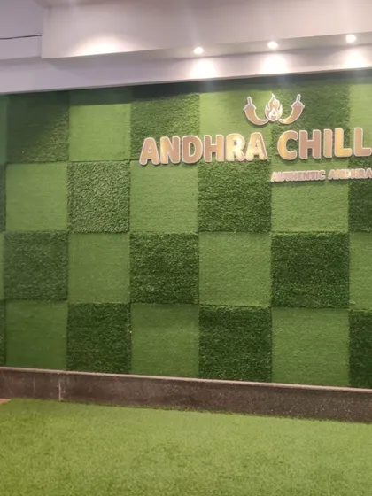 Another angle of the artificial green wall, showing how it integrates with the restaurant's signage and overhead lighting to create a welcoming ambiance.