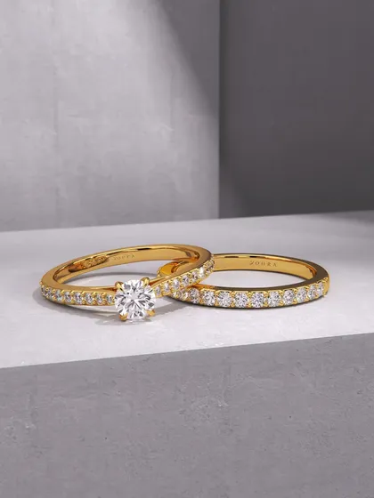 A perfect pair. This set includes a classic diamond solitaire engagement ring and a matching full eternity diamond band, both crafted in 18k yellow gold. I design these sets to symbolize a bond that is both brilliant and everlasting.