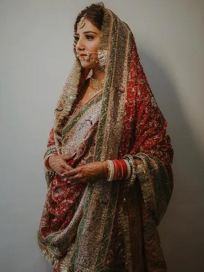 A classic, poised portrait of a bride wearing her mother's vintage wedding attire.