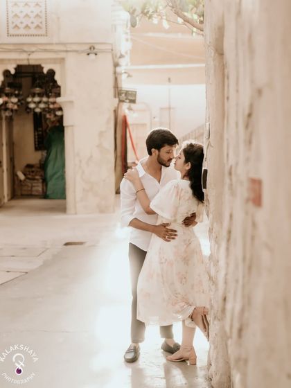 An intimate embrace in a beautifully lit alleyway in Dubai, capturing a moment of pure romance.