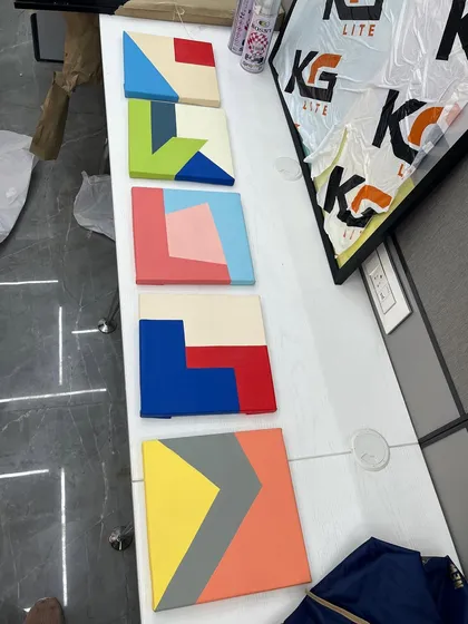 A top-down view of the small, colorful geometric canvases, highlighting their clean lines and bold color-blocking.