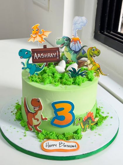 A simple plan turned into a Jurassic adventure! This dinosaur-themed cake for a 3rd birthday is filled with happy dinos, a volcano, and lush green textures to create a prehistoric world.