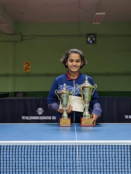 Harshika K with her two trophies after a fantastic double-title win in the U15 and U17 girls' events.