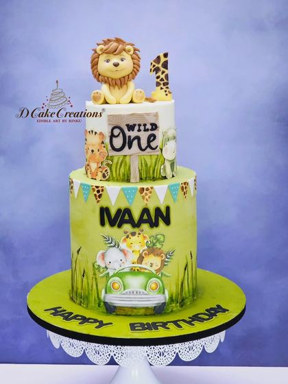 Another take on the popular "Wild One" theme for Ivaan's first birthday. This two-tier cake features a hand-painted safari jeep and adorable jungle animals.